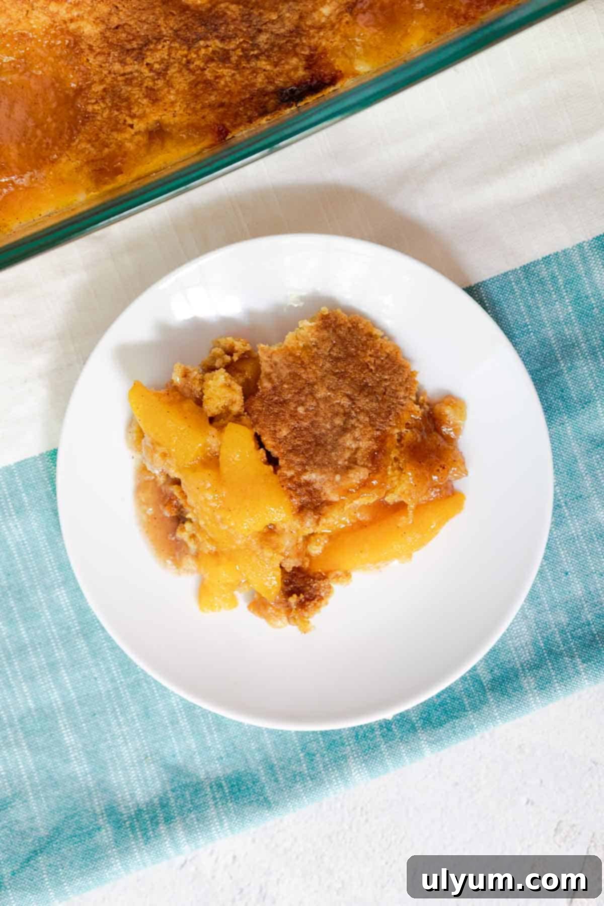 A serving of peach cobbler on a small plate.