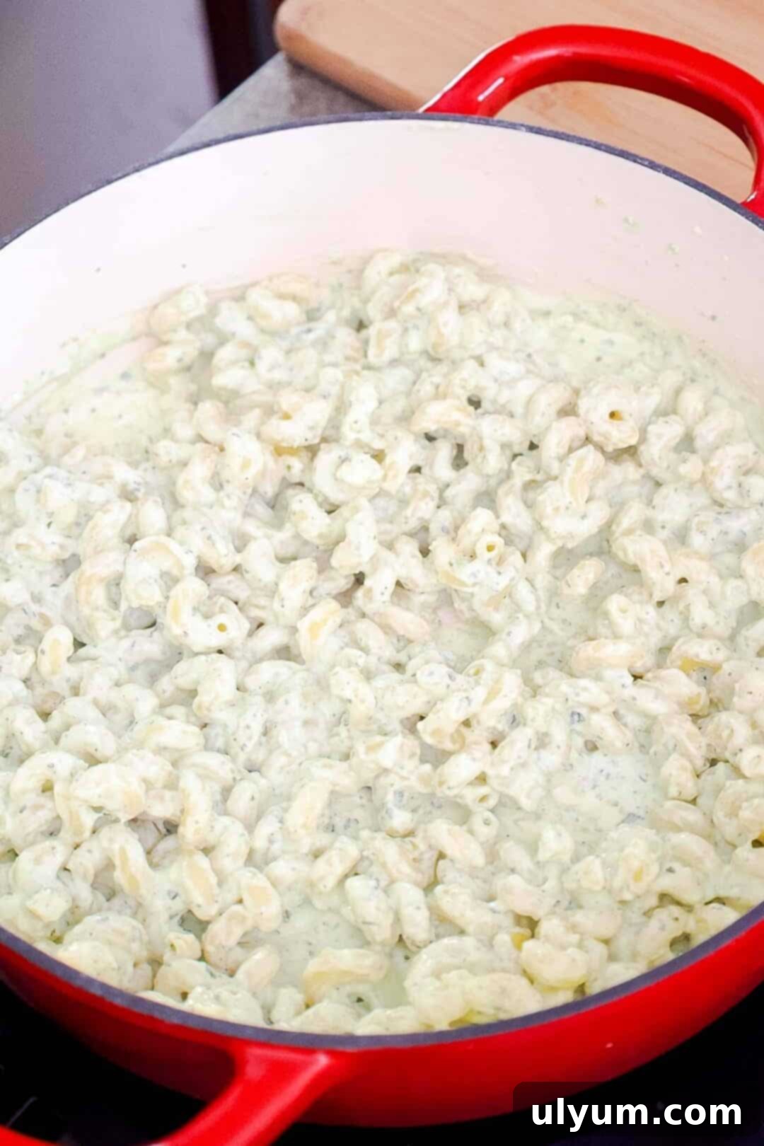Spicy Creamy Jalapeño Ranch Pasta 9 Pasta stirred into creamy jalapeño ranch sauce in a large pot.