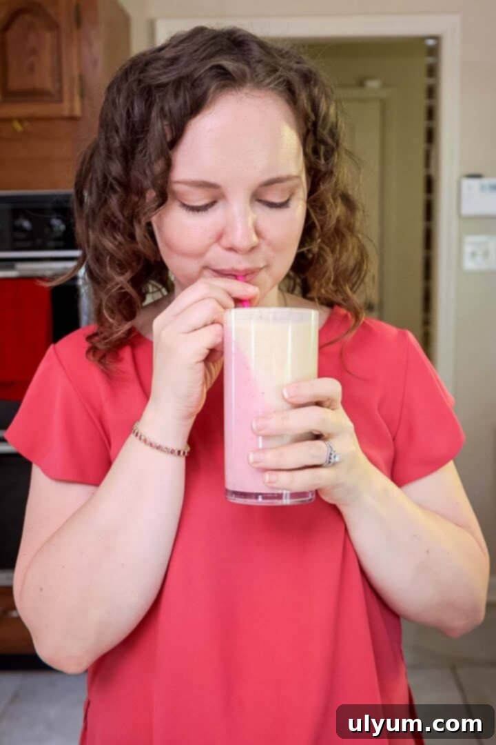 Kelsey Smith drinking a two-toned peanut butter and jelly smoothie.