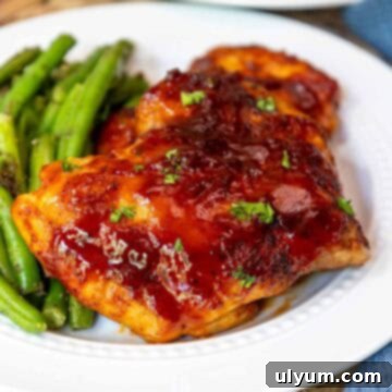 Mouthwatering Oven Baked BBQ Boneless Chicken Thighs 12 Oven baked BBQ boneless chicken thighs plated with green beans.