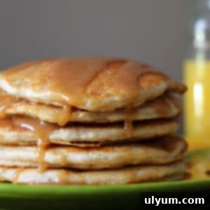 Stack of banana pancakes with syrup drizzled on top, ready to eat.