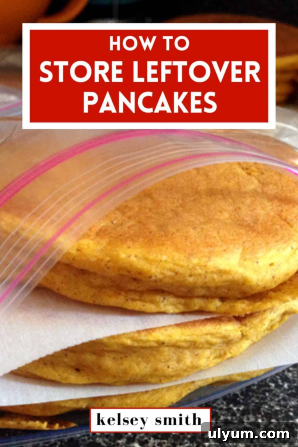 Pancakes stacked in a food storage bag with parchment paper between the layers, ready for storage.
