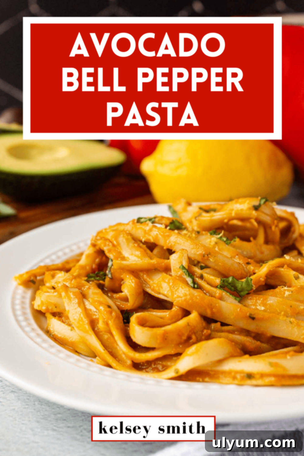 Avocado bell pepper pasta served on a plate with fresh basil garnish. The prominent text above reads 'Avocado Bell Pepper Pasta'.