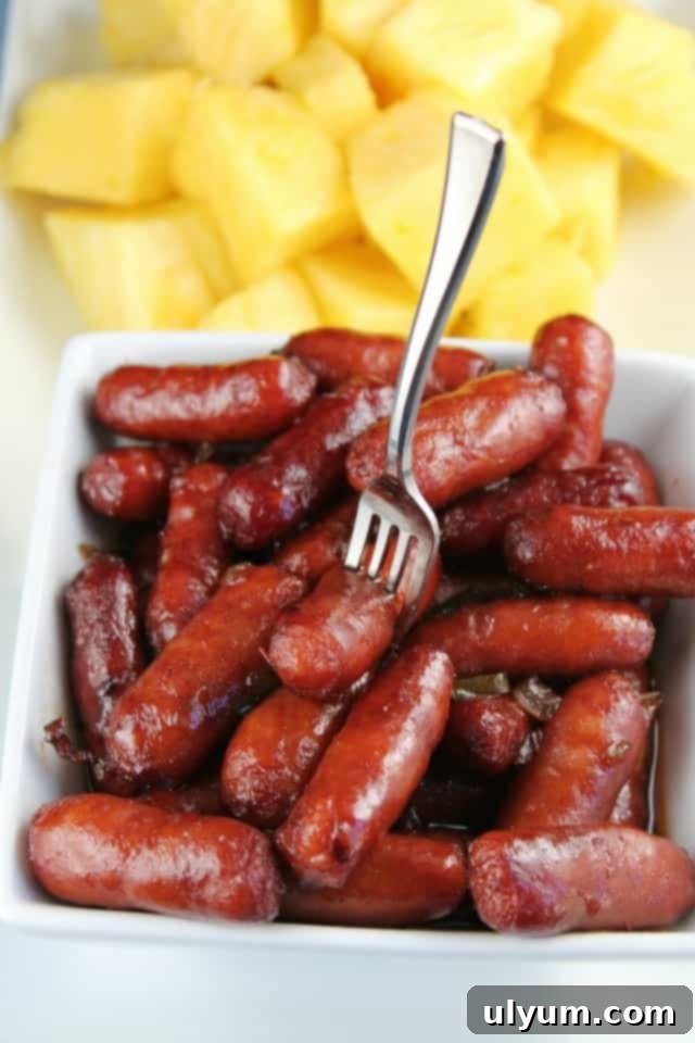 Score Big: 48 Instant Pot & Slow Cooker Game Day Eats 17 Slow Cooker Grape Jelly Cocktail Wienies, a classic sweet and savory party snack.