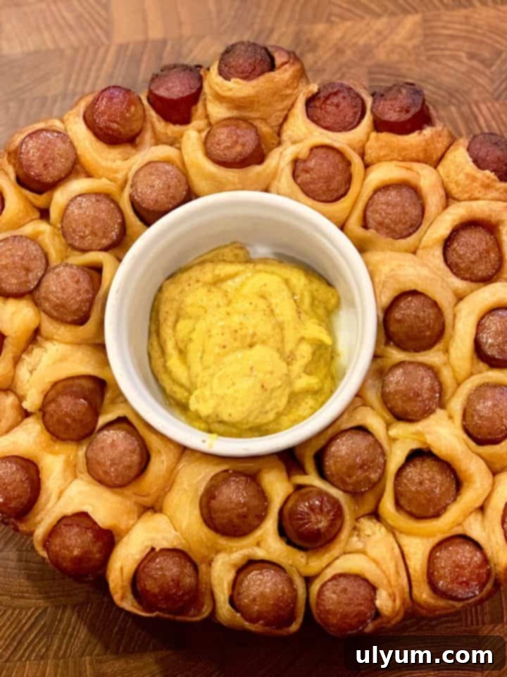 Score Big: 48 Instant Pot & Slow Cooker Game Day Eats 22 Slow Cooker Hot Dog Pull Apart, a fun and easy appetizer.