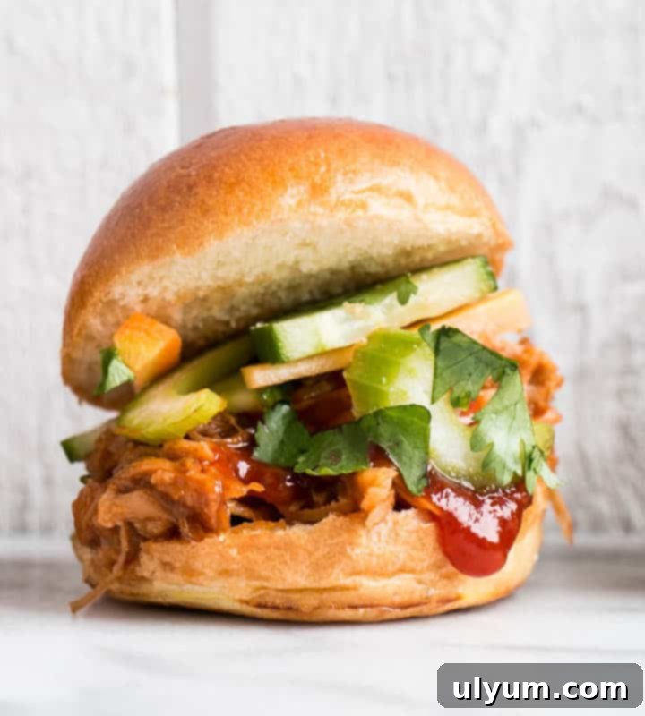 Score Big: 48 Instant Pot & Slow Cooker Game Day Eats 46 Slow Cooker Korean Pulled Pork Sliders with quick pickle vegetables.