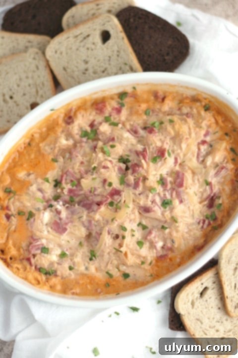 Score Big: 48 Instant Pot & Slow Cooker Game Day Eats 5 Healthier Slow Cooker Reuben Dip served with rye bread crackers.