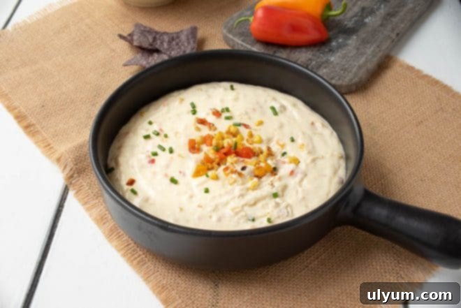 Score Big: 48 Instant Pot & Slow Cooker Game Day Eats 6 Slow Cooker Corn and Pepper Cheese Dip, a creamy sweet and savory dip.
