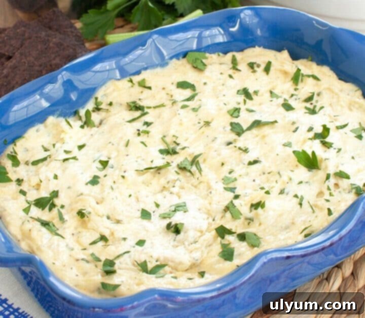 Score Big: 48 Instant Pot & Slow Cooker Game Day Eats 8 Slow Cooker Garlic Parmesan Chicken Wing Dip, a savory appetizer.