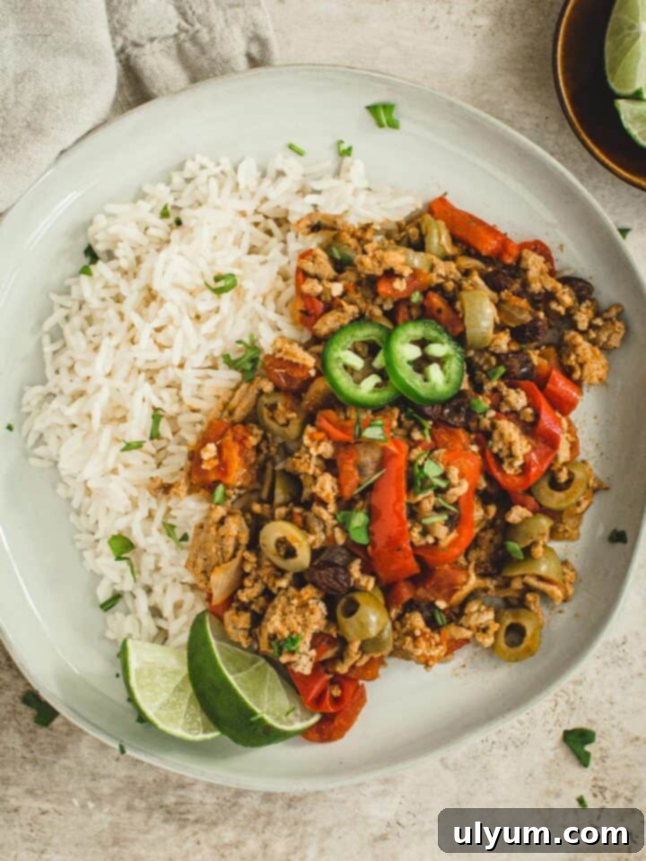 Instant Pot 20-Minute Picadillo with ground beef, bell peppers, green olives, and raisins.