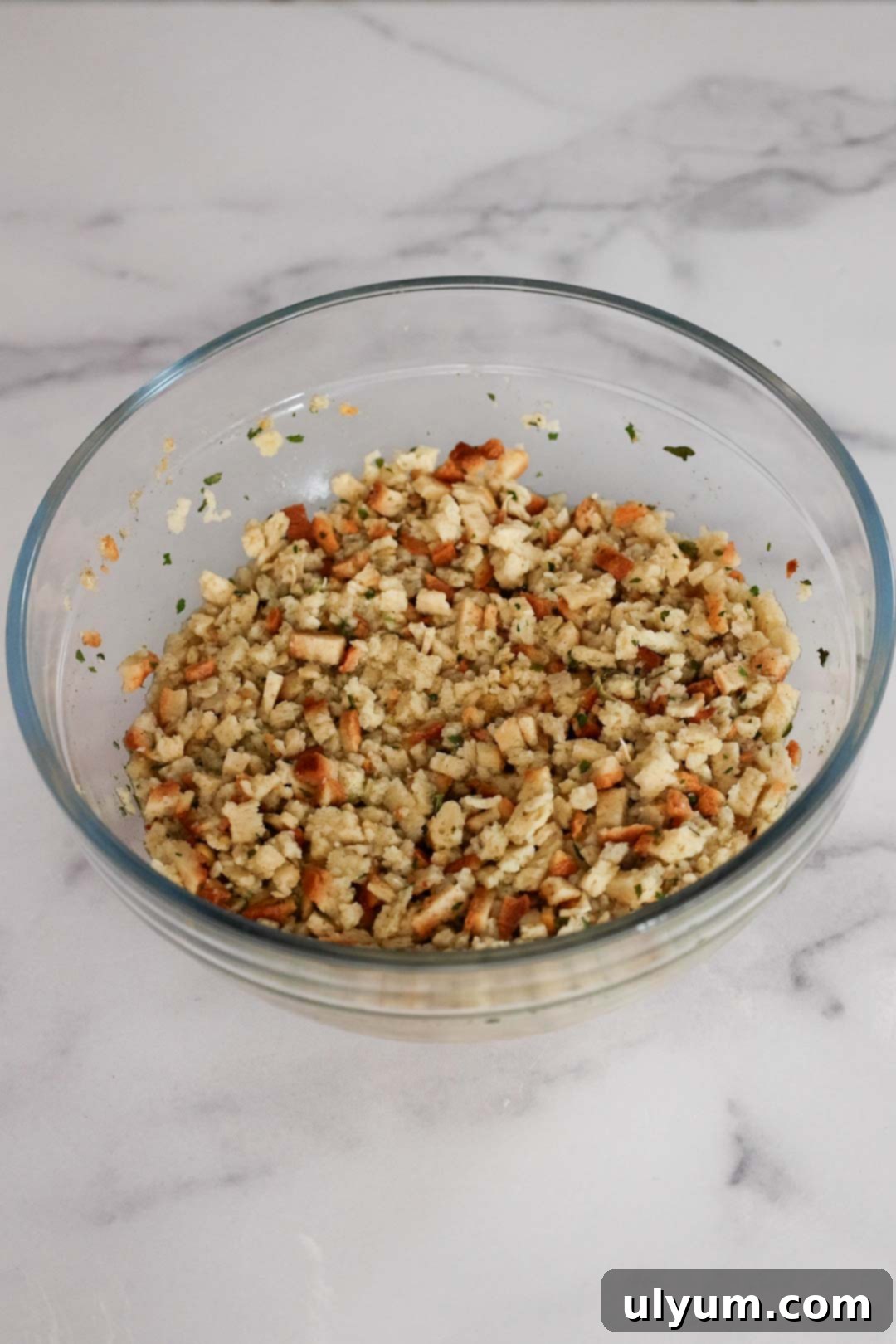 Prepared stuffing mix in a glass bowl.