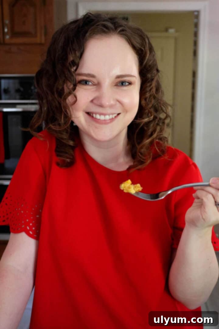 Kelsey Smith holding a forkful of peach cobbler.